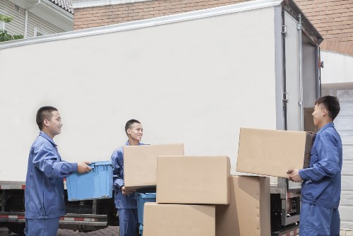 Furniture collection team handling bulky items in an Ealing residential street