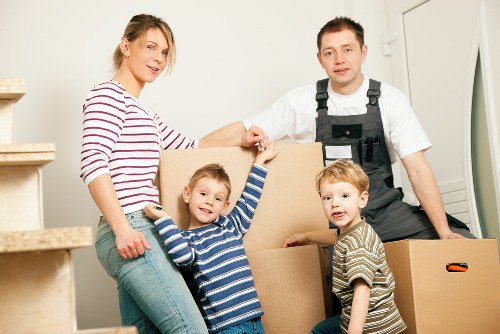 Helper loading boxes into van for an Ealing move