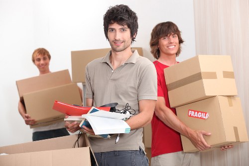 Boxes and furniture being loaded into a van for transport