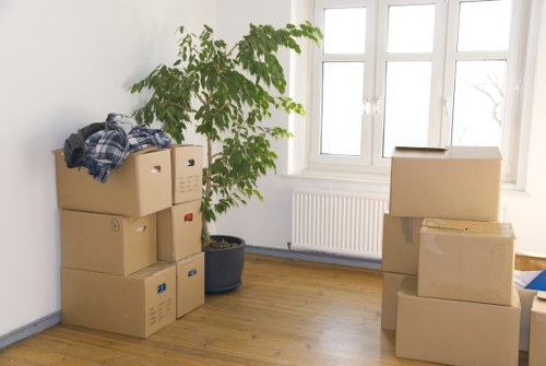 Packed moving boxes and furniture ready for transport in West London