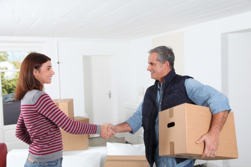 Local moving truck loading furniture and boxes in West London