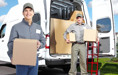 Boxes and furniture being loaded into a local removals van