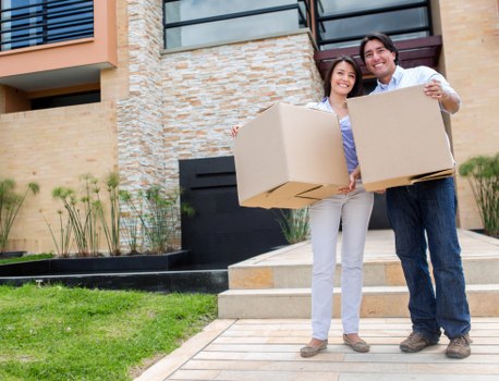 Insured man with van Ealing service handling boxed belongings carefully
